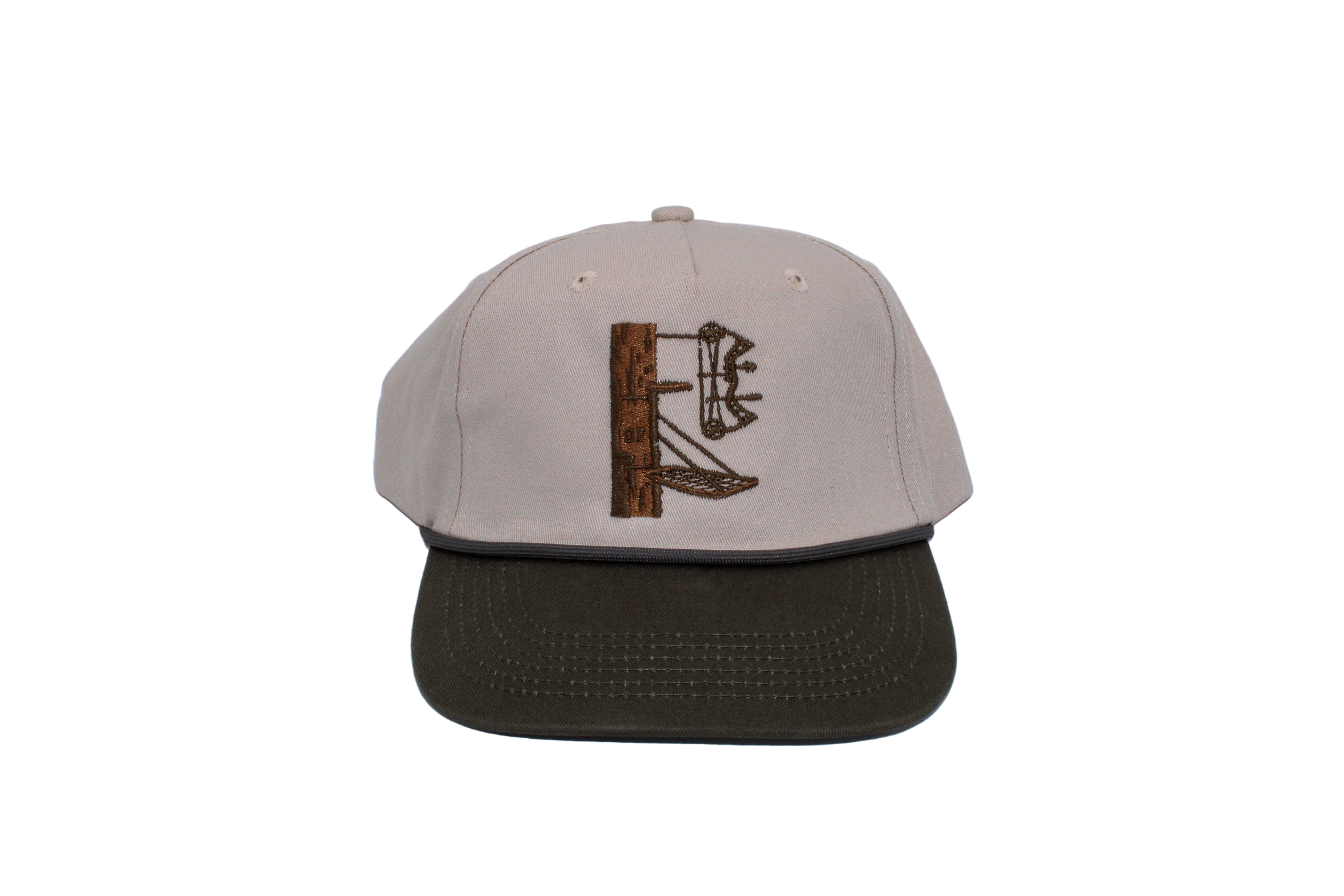 A lock on stand with a bow on a cream hat with a green bill. The letters DF are carved into the tree